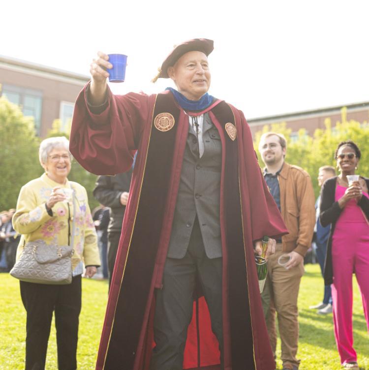 Dr. Theodore Karamanski toasting Loyola graduates, May 2023